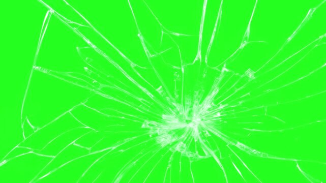 Glass impact crack with detailed fractures on a green screen, Abstract broken glass Cracked and Shattered animation. Green Screen Shatter Animation for VFX and Video Editing, dust and scratches film.
