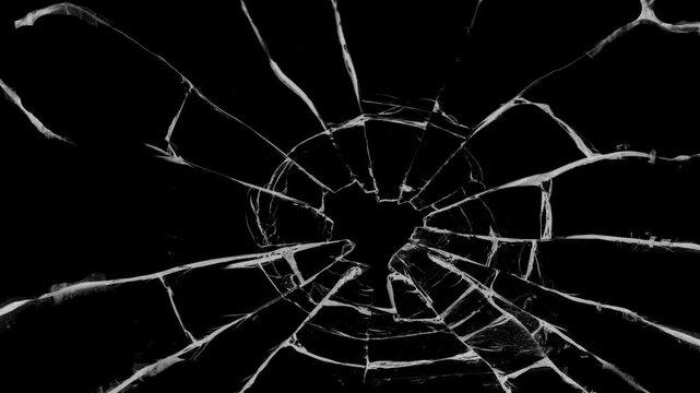 Shattered glass animated overlay, transparent 4K video, simulating broken glass effects.  Shattered black glass realistic footage. cracks glass fracture effect texture isolated abstract black bg.