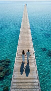 Two figures, man and woman, walk on wooden pier into calm blue ocean, enjoying peaceful moment, nature, serenity, connection, relaxation, tranquility, family, springtime festivity., Stepfamily Day