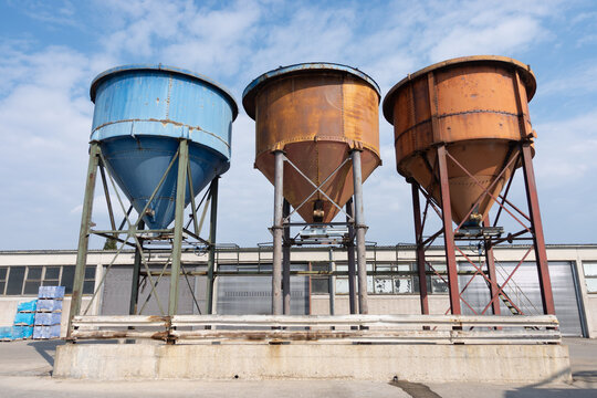 Weathered Industrial Silos Under Blue Sky