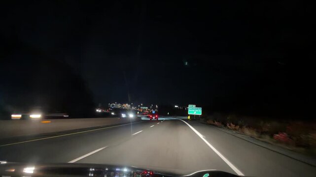 First-person windshield view: high-speed night driving on busy Halifax bypass ring road. Heavy traffic, oncoming headlights streak, city lights reflect on wet summer asphalt, Nova Scotia Canada 4K.