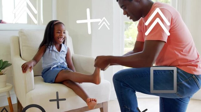Parenting girl sitting barefoot on chair near window, father kneeling showing shoe, helping fit