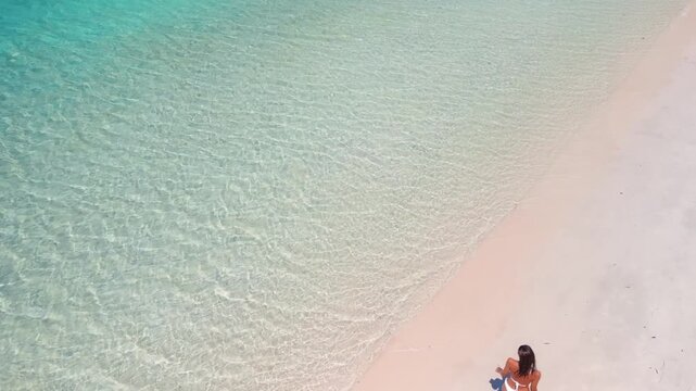 Aerial View of Woman Walking on Tropical Beach with Clear Turquoise Sea