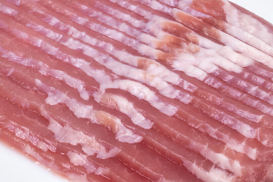 Factorystyle bacon with consistent slices and packaging. Manufacturinggrade bacon sheet with parallel slices ideal for streamlined production and packaging processes