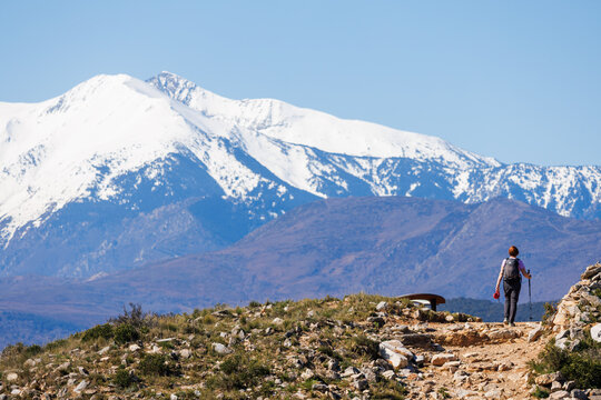 Arriv&eacute;e d'une randonneuse au sommet du Roc de Majorque au pied du canigou enneig&eacute;