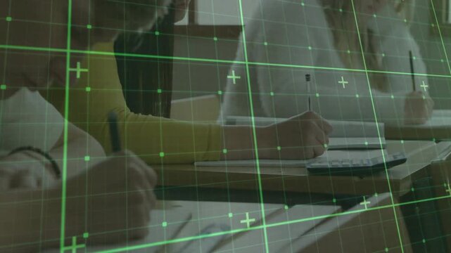 Students writing at desks in classroom, camera focusing, green grid covering pens and calculator