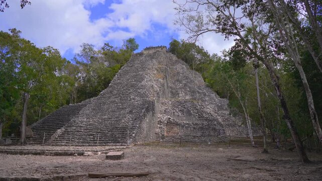 Ancient ruins of Mayan pyramids at the archaeological site of Coba on the Yucatan Peninsula, Mexico. Majestic stone structures surrounded by jungle nature. History, culture and travel exploration
