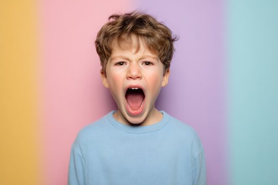 Playful boy pretending to roar like dinosaur