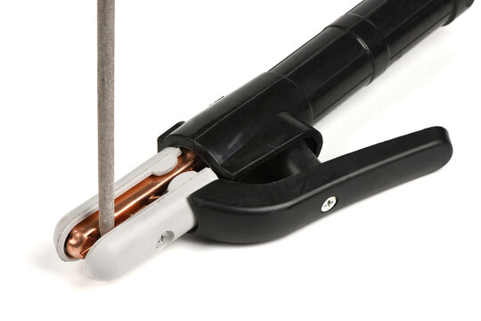 Close-up of welding electrode holder clamp gripping a rod