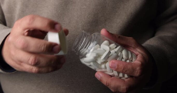 A patient opening a transparent pharmacy bottle to access their daily medication for wellness and preventive healthcare solutions.