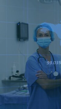 Vertical video: Raising hands on cue, nurse in blue scrubs crossing arms in OR preparing with steth