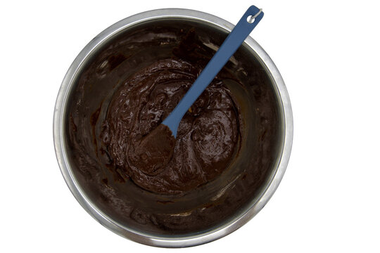 looking down into a mixing bowl with moist brownie mix on a transparent background 