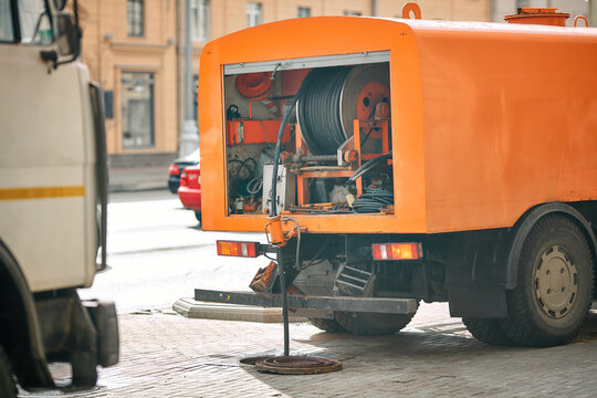 Utility truck deploying underground cables for telecom or electrical systems in urban infrastructure projectject. Underground cable laying truck with large reel system operating on city street
