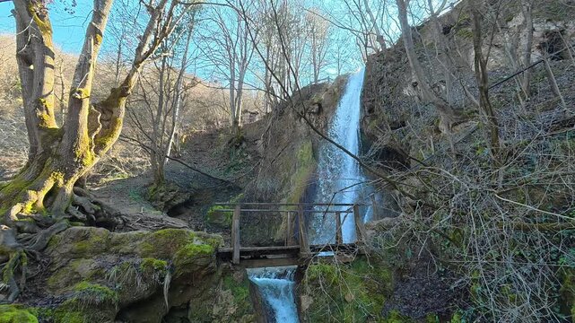 Distant Side View of Forest Waterfall with Tree &ndash; Autumn Clear Sky. Ozren Mountain, Sokobanja region (Ripaljka Waterfall). Balkans, Serbia.