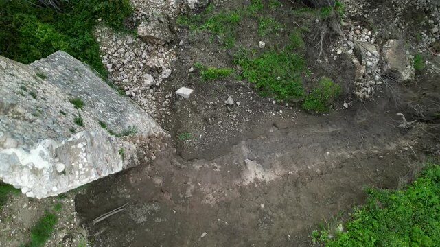 A landslide and collapse, an environmental disaster and destruction. The historic fortress wall collapsed during heavy and prolonged rains. Rocks, mud, and debris completely buried parked cars.