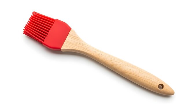 Red silicone basting brush with wooden handle on white background ideal for cooking and baking applications in kitchen utensil collections