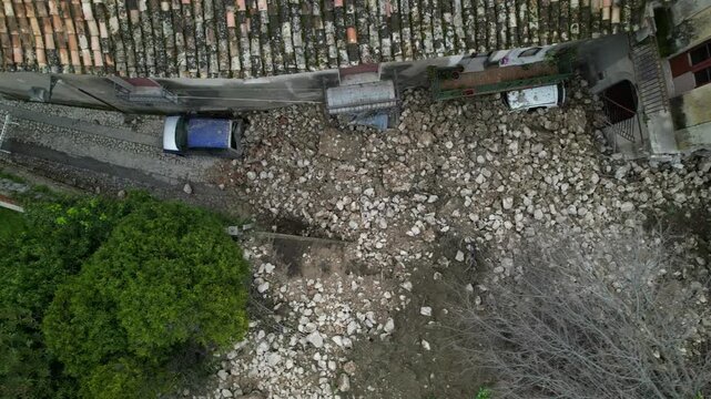 A landslide and collapse, an environmental disaster and destruction. The historic fortress wall collapsed during heavy and prolonged rains. Rocks, mud, and debris completely buried parked cars.