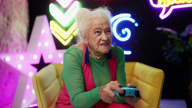 Humorous elderly woman playing video game with gamepad, active senior lifestyle