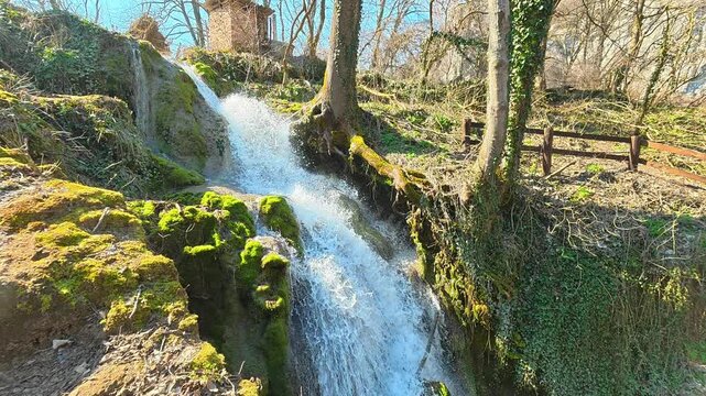 Side View of Forest Waterfall Filmed Upward on Sunny Autumn Day. Ozren Mountain, Sokobanja region. Balkans, Serbia.
