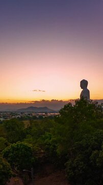 Timelapse of the standing Buddha at Tong Lam Son Temple Lo Son in Nha Trang, Vietnam. Sunset sky transitions into evening 