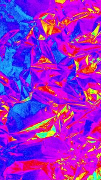 Abstract holographic foil background with psychedelic neon colors. Vibrant liquid metallic texture with animated colorama transitions and organic film grain.