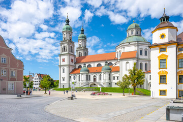 St. Lorenz Basilica stands majestically in Kempten, Bavaria, showcasing its baroque architecture against a backdrop of vibrant blue skies and picturesque clouds. © pyty