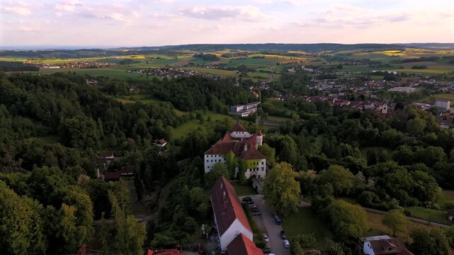 Drone footage Ortenburg Castle in Lower Bavaria, showing Alt-Ortenburg and Vorderschloss. Renaissance architecture, castle garden. Luftaufnahme Schloss Ortenburg, in Marktes Ortenburg, Deutschland. 