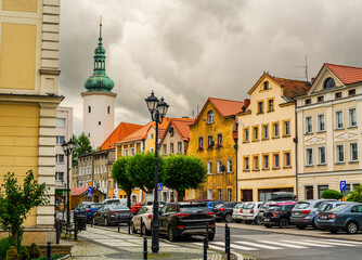 Obraz premium 2025-07-18; Historic townhouses and town hall tower in Mirsk, Poland.