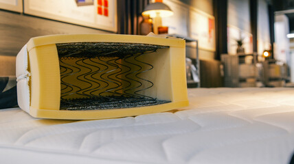 Fototapeta premium Cross section of a mattress showing springs and foam layers for comfort and support