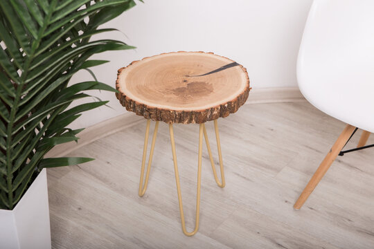 Oak cross section wooden table where the crack is filled with epoxy