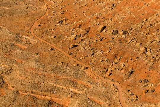 USA, Arizona, Mexican Hat.  Empty desert road viewed from above at Muley Point.