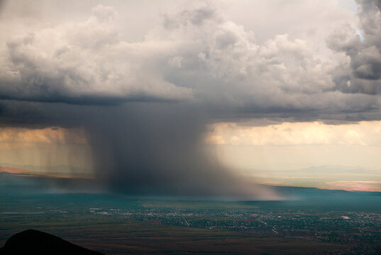 USA, Arizona, Sierra Vista.  Storms over the San Pedro River Valley viewed from Carr Peak in the Huachuca Mountains