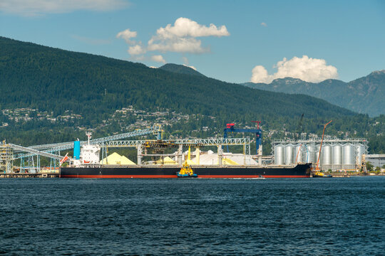 Canada, BC, Vancouver.  Bulk cargo ship at terminal in North Vancouver, loading sulphur.
