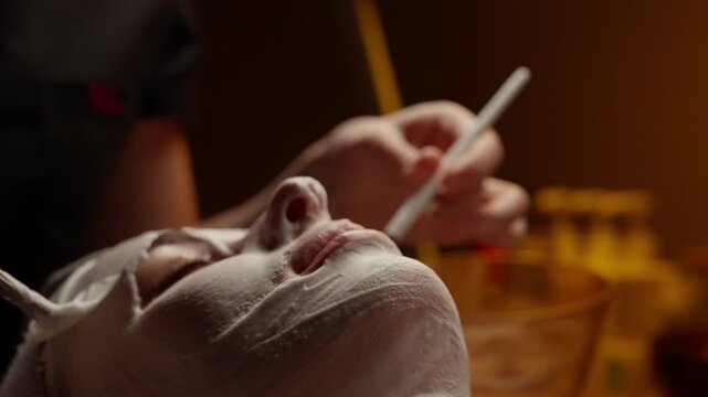 Relaxing spa facial treatment with soothing white mask application on face and neck, highlighting skincare pampering, wellness, and calming beauty ritual
