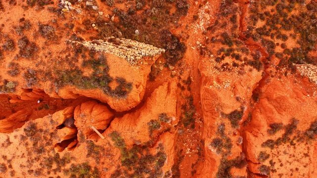 Moving over the rocky area curved by the water or wind erosion. Some lichens and mosses grow in the area.