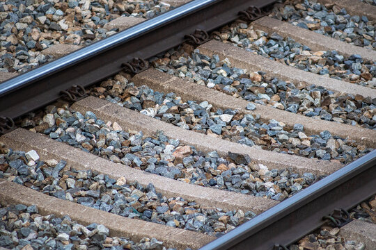 Parallel train tracks on stony ballast evoke direction, journey, and engineering precision.