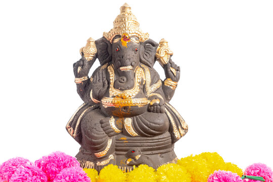 Ganesha statue with gold accents surrounded by bright marigold garlands for spiritual and cultural decoration.