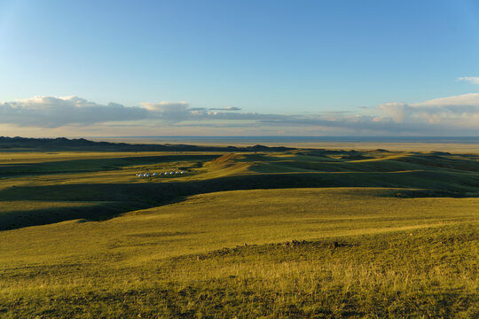 Serene Sunset Over a Traditional Ger Camp in the Vast Mongolian Steppe