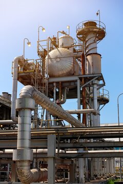 deaerator tank and chimney of boiler at powerplant against a clear blue sky, representing manufacturing and energy production.