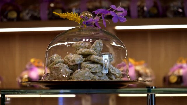 Pistachio amaretti inside glass tray. Pastry shop. Easter decorations. Panning 4K