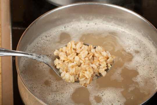 We cook oatmeal porridge over low heat in a saucepan.