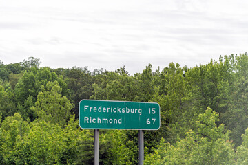 Richmond Fredericksburg road sign on Virginia interstate i-64 highway with distance sign in summer