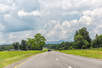 Blue ridge mountains by Virginia US South 29 highway road, cars driving in summer rural countryside village town with scenic landscape
