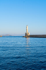 Fototapeta premium bay of Chania with sea and lighthouse at sunny summer sunset, Crete, Greece, web banner format