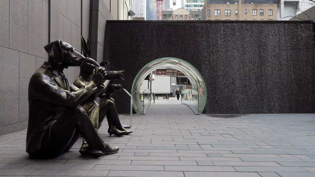 New York, USA. Paparazzi Dogman and Paparazzi Rabbitgirl statue, Plexiglass Waterfall Tunnel at McGraw Hill Park in Midtown Manhattan