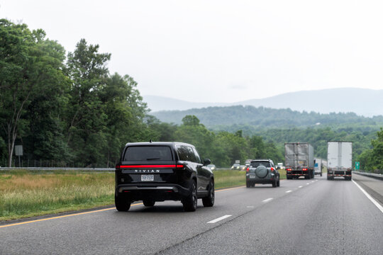 Crozet, USA - May 27, 2025: Virginia highway i64 blue ridge mountains road with pov of black Rivian truck car on cloudy day and sign