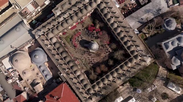 Top aerial drone view of the historic Koza Han courtyard and Ottoman bazaar complex in Bursa, Turkey.
