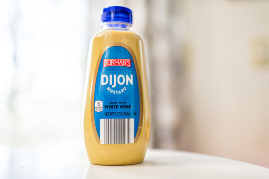 Roseland, USA - February 13, 2025: Dijon mustard bottle by Aldi private label Burman's brand food macro closeup studio shot made with white wine