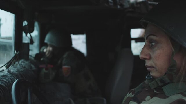 Profile view of a determined woman in military camouflage uniform driving an army truck