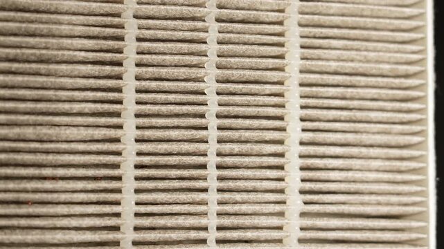 Replaceable HEPA air filter macro close up. Filter for air purification from fine dust and odours and other allergen air pollution. Helps breathing better by trapping pollutants in the air.